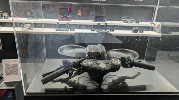 MOZA x MotoGP handlebar controller on display at Gamescom 2026, showing the dual-grip design and backlit button layout