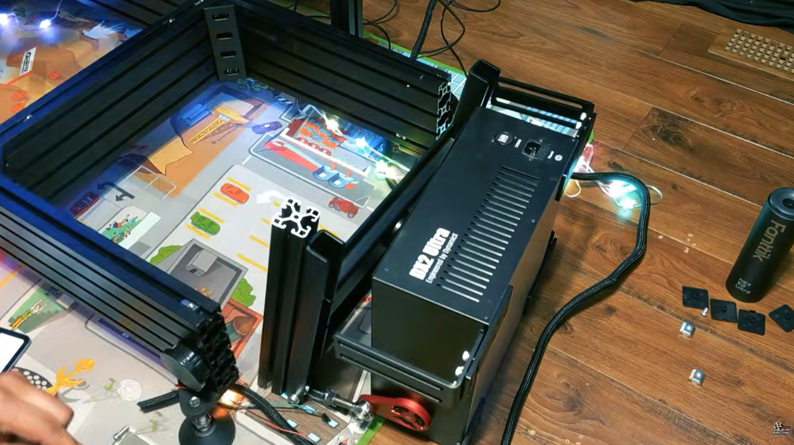 DX2 Ultra seat mover installed between a sim racing seat and an aluminum profile cockpit