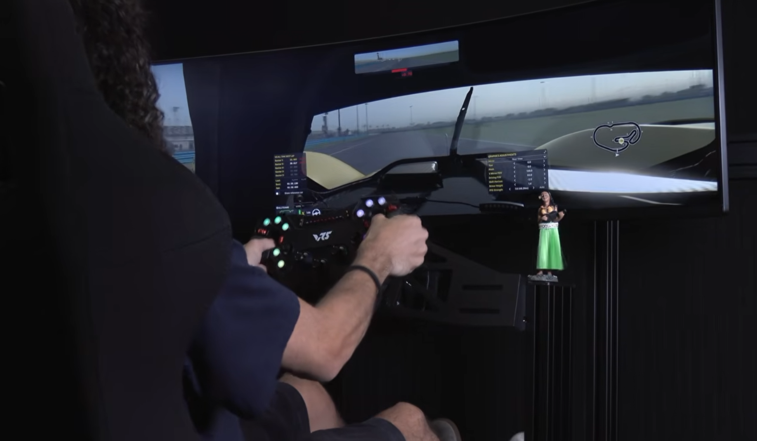 Sim racer driving a 3DOF motion rig with an attached monitor during ISR's monitor mounting test